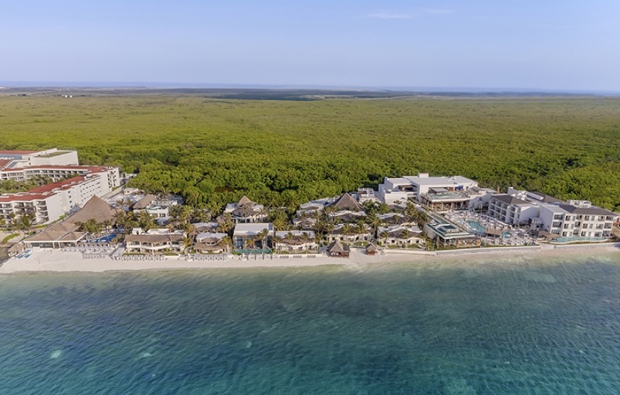 Beachfront pool and palapas at Desire Riviera Maya Resort